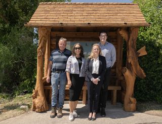 Nicola Wheeler and creative team stand in front of the new Emmerdale bus stop.