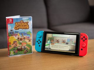 Nintendo Switch Animal Crossing game cover and console