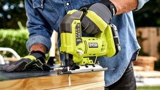 Close up of lime green Ryobi jigsaw in action
