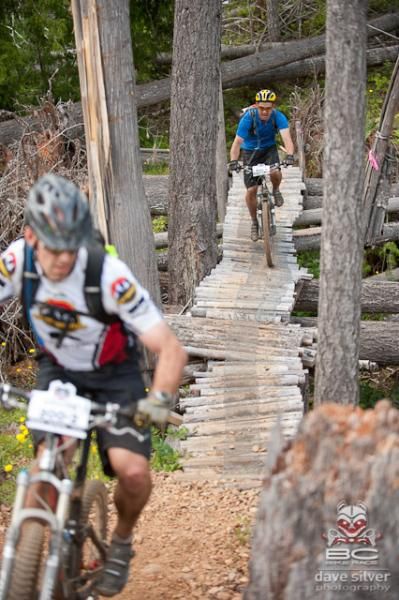 Riders pick their line across a wooden bridge