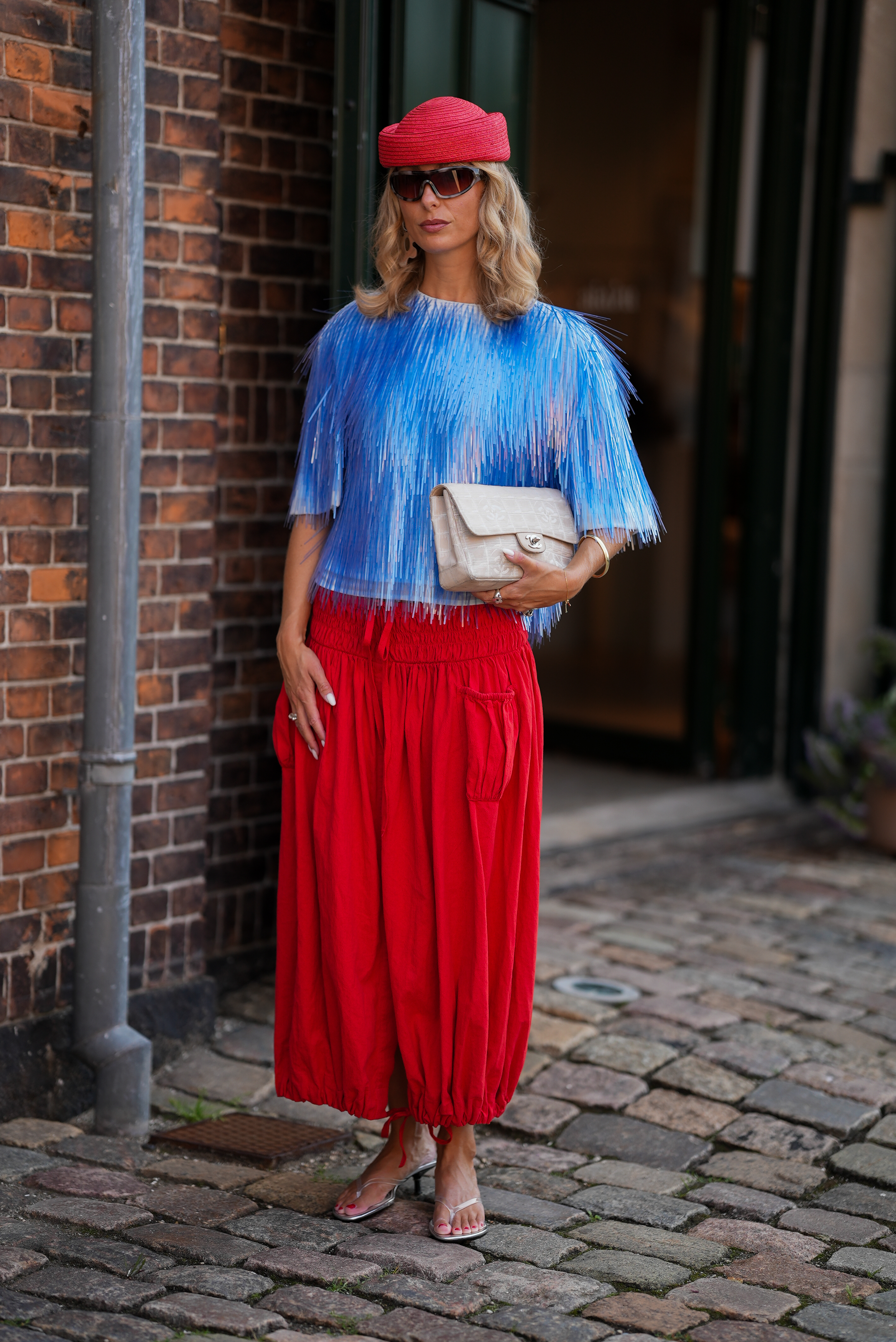 A guest at Copenhagen Fashion Week wore the red-and-blue color combination trend
