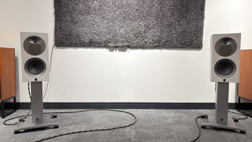 Arendal 1528 Bookshelf 8 standmount speakers on grey carpet in front of white wall 