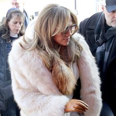 Actress and singer Jennifer Lopez wears a fur ivory jacket with white pants and boots as she attends the Sundance Film Festival in Park City, Utah.