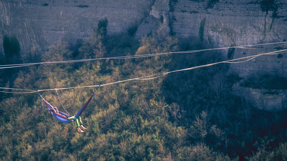 No, people aren't really 'sky camping' by sleeping in hammocks above