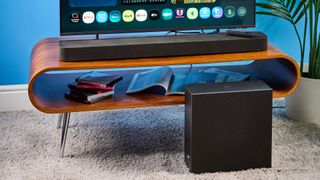 the sony bravia theater bar 7 photographed with the subwoofer with a TV on the tom's guide blue background