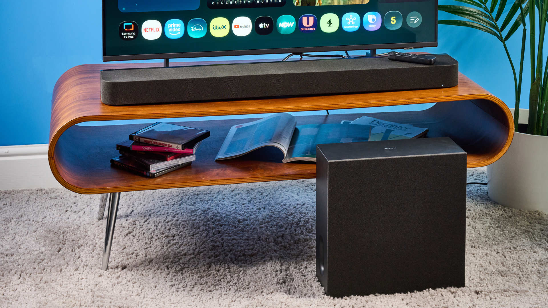 the sony bravia theater bar 7 photographed with the subwoofer with a TV on the tom's guide blue background