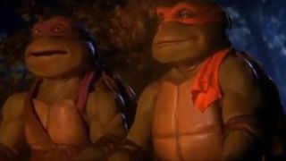 Donatello and Michelangelo sitting by a fire in Teenage Mutant Ninja Turtles