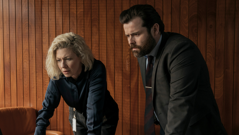 Two police officers look at a computer screen