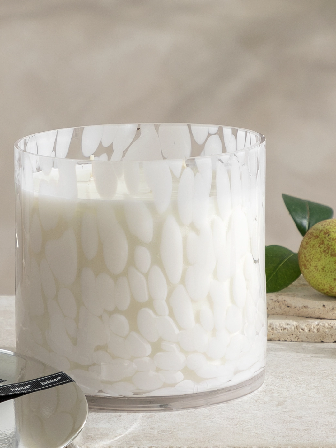 A speckled glass candle with pear scent from Habitat