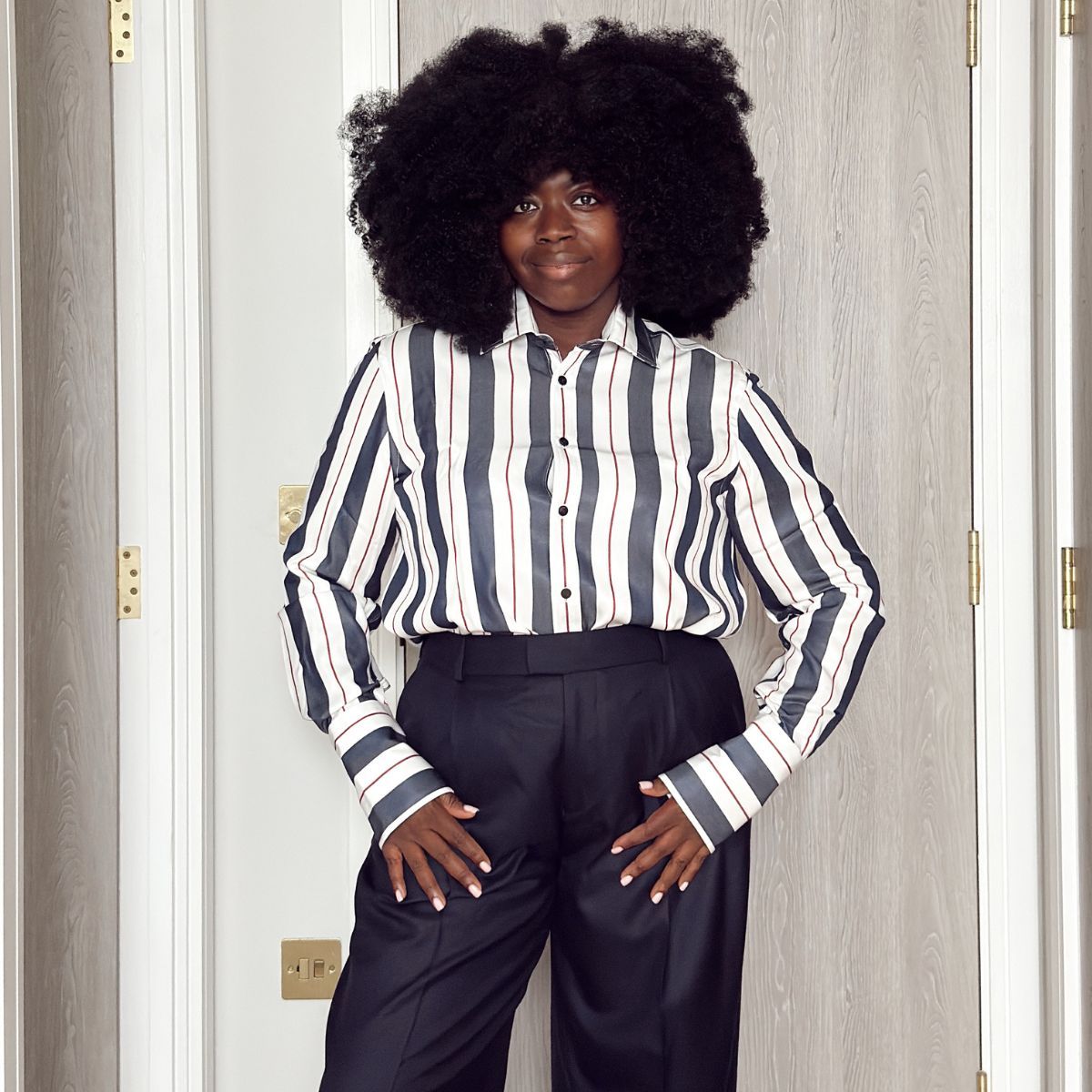 Stephanie Yeboah wearing a shirt and trousers from With Nothing Underneath
