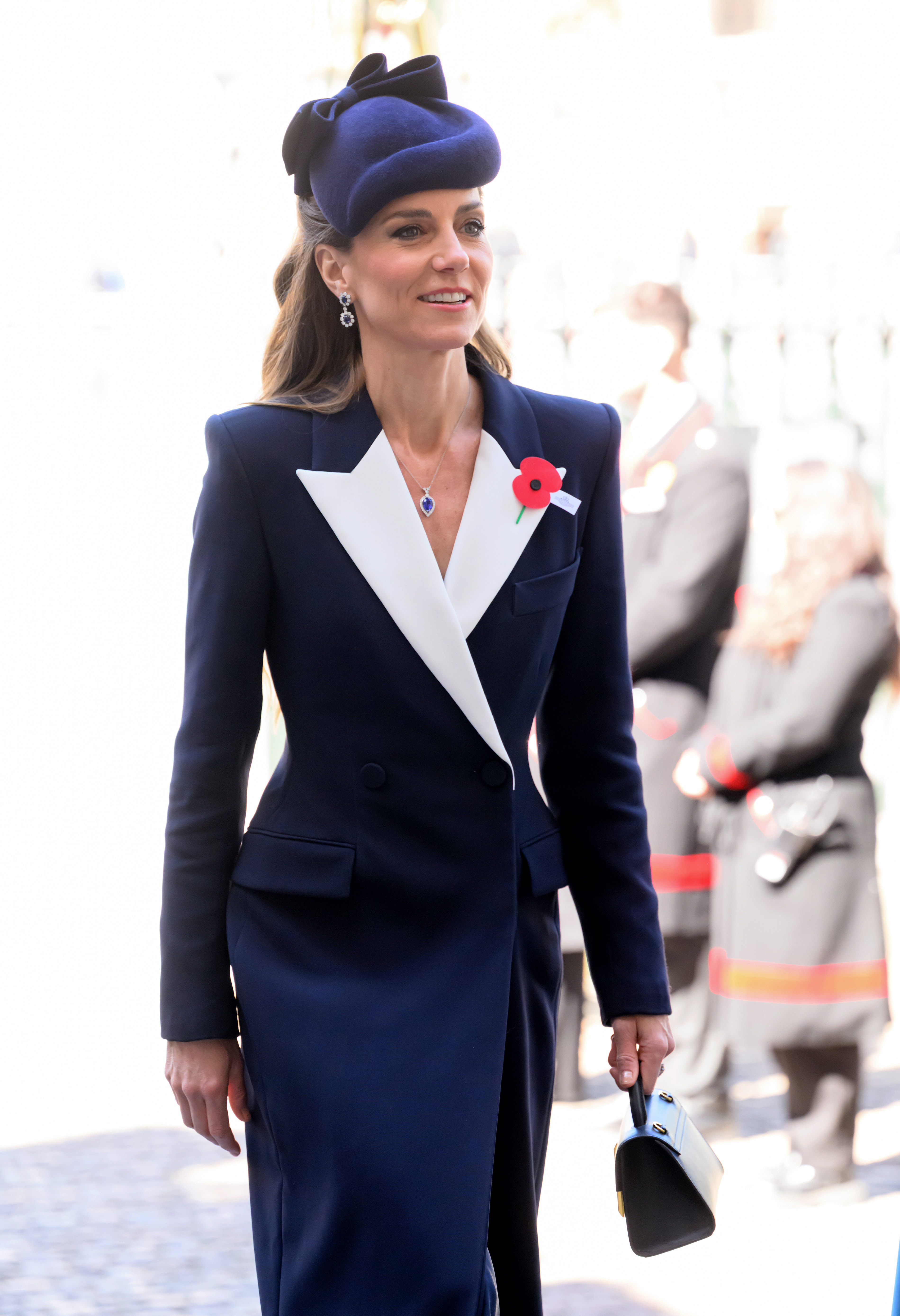 Kate Middleton wearing a coat dress from ALEXANDER MCQUEEN with jewelry from Prince William and Princess Diana