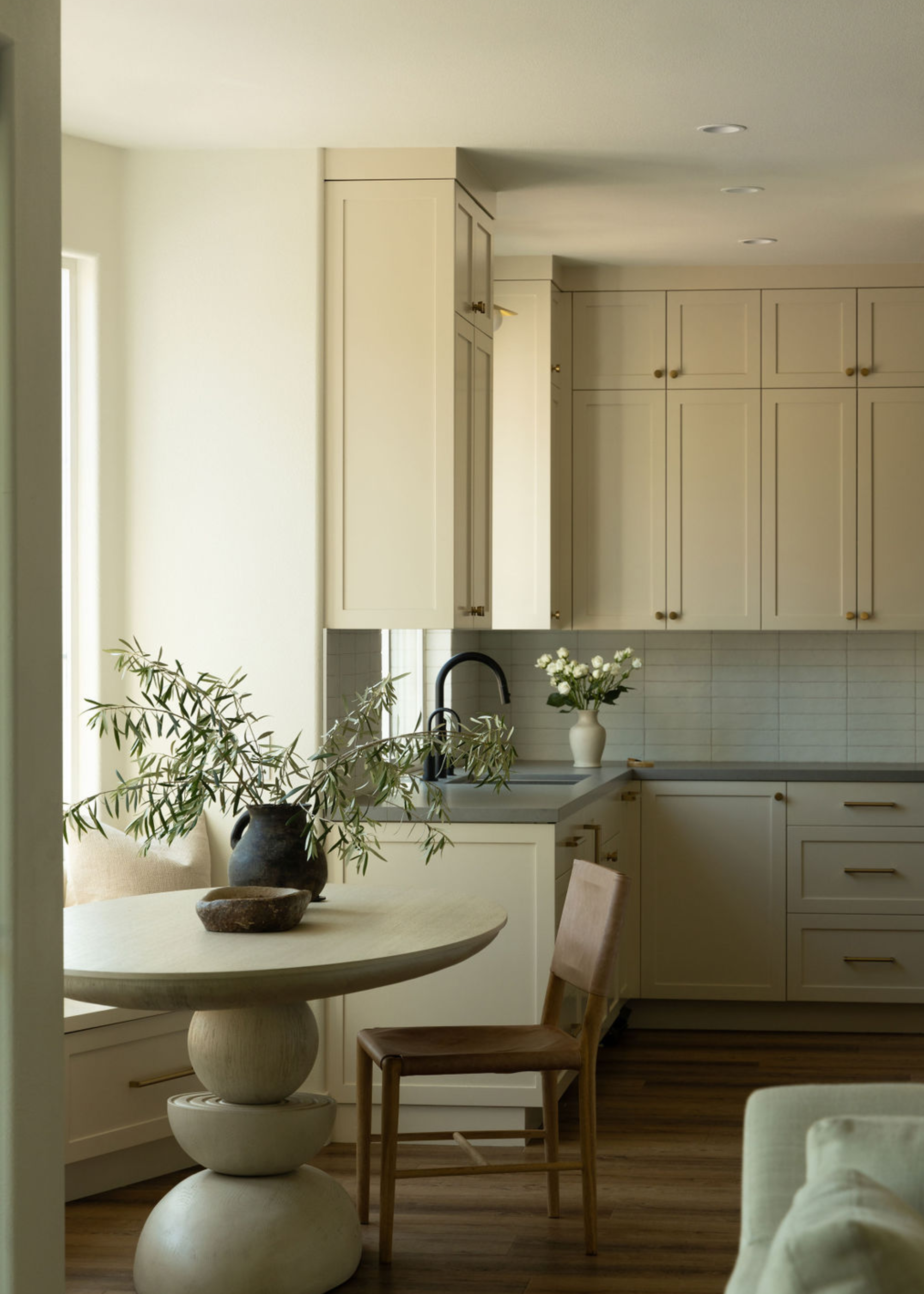 a neutral kitchen with off white cabinetry