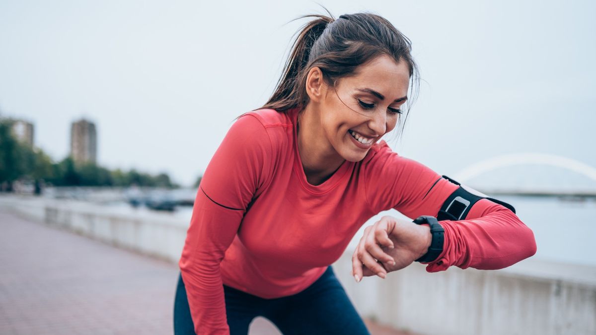 Woman checking GPS watch during run