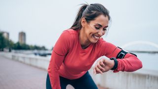 Woman checking GPS watch during run