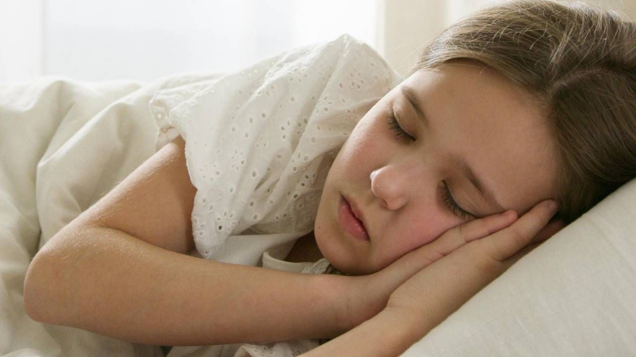 A child asleep on a bed