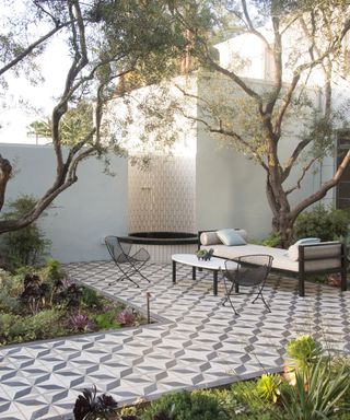 A cool tiled seating area under the shade of trees