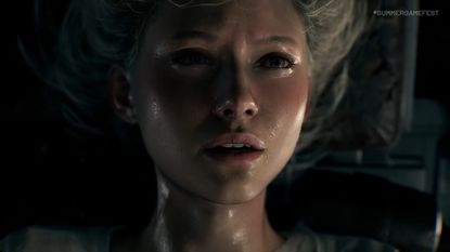 A screenshot shows a woman's face damp with sweat 