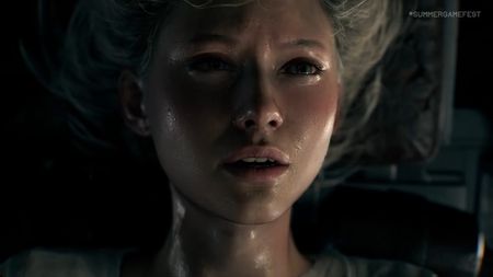 A screenshot shows a woman's face damp with sweat 