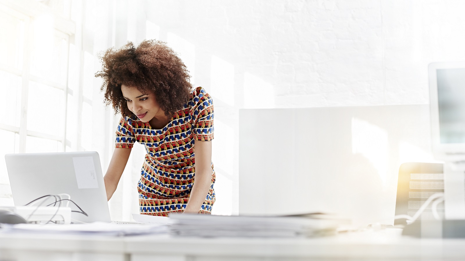 A young woman at work on a computer.