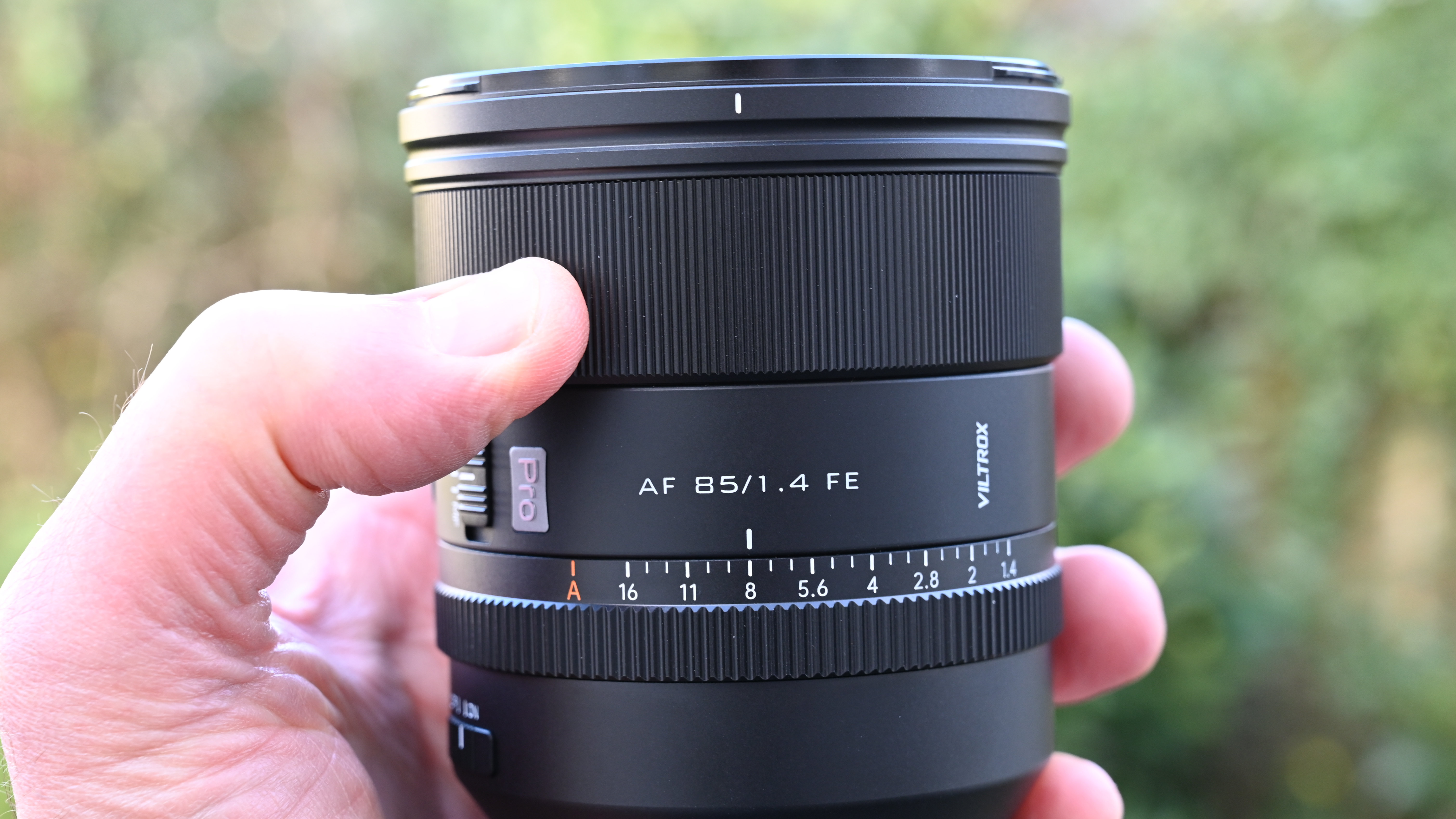 Viltrox AF 85mm f/1.4 Pro product shot, lens in hand