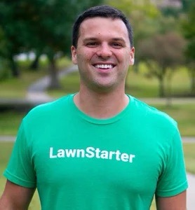 Ryan Farley has dark brown short hair and is pictured smiling in a green t shirt outdoors 
