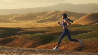 Running leggings deals: Woman running outside