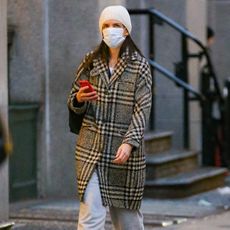 Katie Holmes wearing a plaid coat with sweatpants