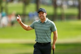 Paul Casey waves to the crowd after holing a putt