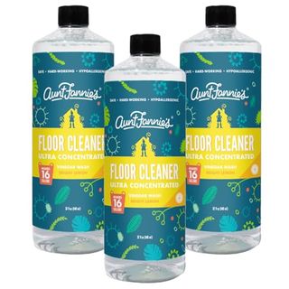 Three pack of plastic bottles with dark green labels that read Aunt Fannie's Ultra Concentrated Floor Cleaner Vinegar Wash, Multi-Surface Floor Cleaner for Mopping, Makes 16 Gallons, Bright Lemon Scent 