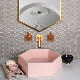 cloackroom with pink sink and small hexagon grey tiles