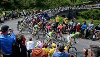 The 2014 Tour de France peloton crosses the Brinton Moor bridge in Yorkshire