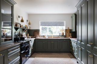dark green inframe wooden kitchen with black AGA range cooker