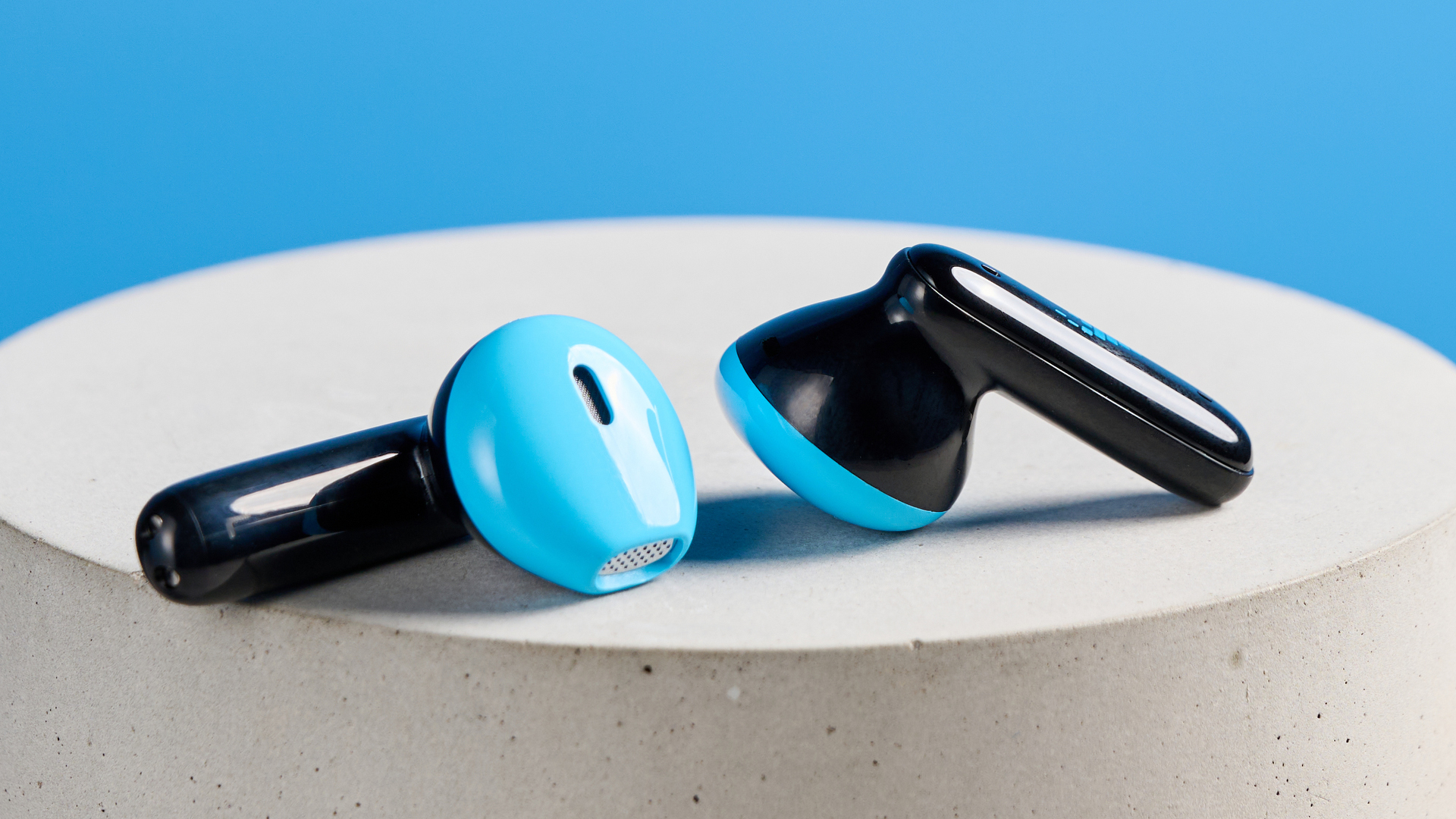 the h2o audio ript-lite earbuds in black and blue, photographed against a blue background, for both working out and everyday use