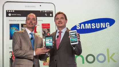 The CEO of Barnes & Noble and president of Samsung Electronics pose with the Samsung Nook