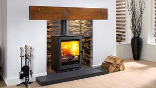 woodburning stove in fireplace with hidden lighting