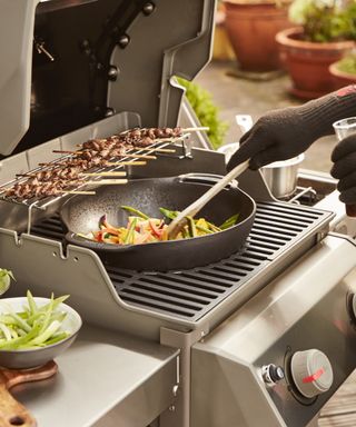A gas grill with three different cooking zones