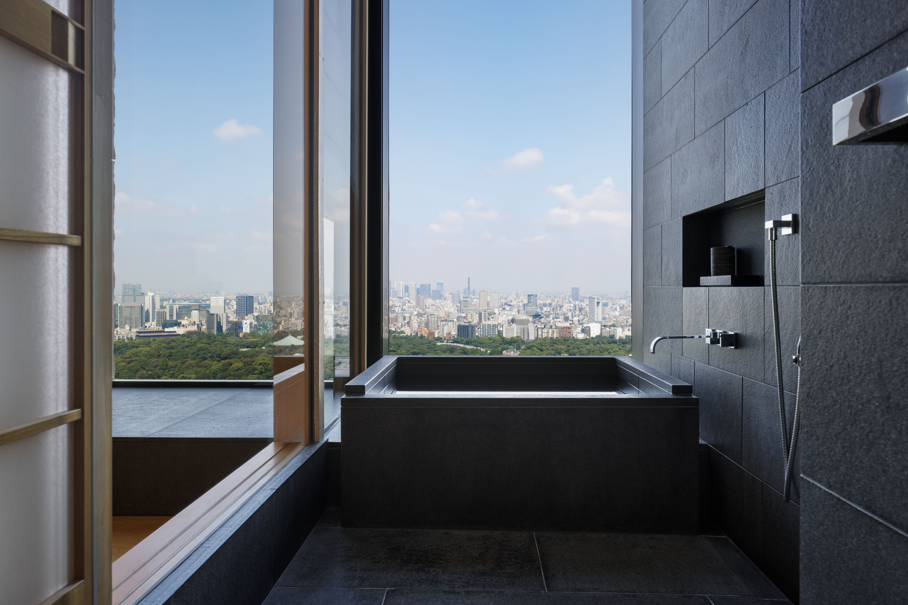view of a serene hotel in tokyo, adorned with wooden furnishing, washi paper and natural stone touches