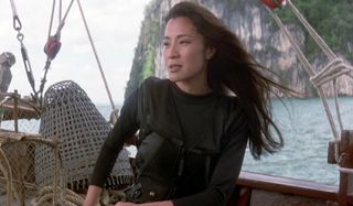 Michelle Yeoh readies her weapons on a boat in Tomorrow Never Dies