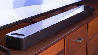 The Bose Smart Soundbar 900 on an entertainment center.