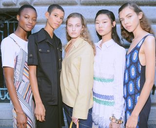 Tory Burch models wear knitted dress, laced dress, yellow shirt, black shirt jacket and multicoloured striped dress