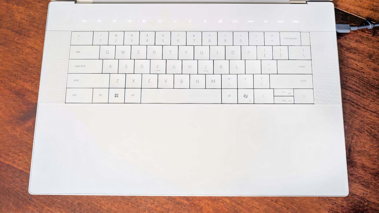 A shot that focuses on the Dell 16 Premium keyboard and invisible touchpad.