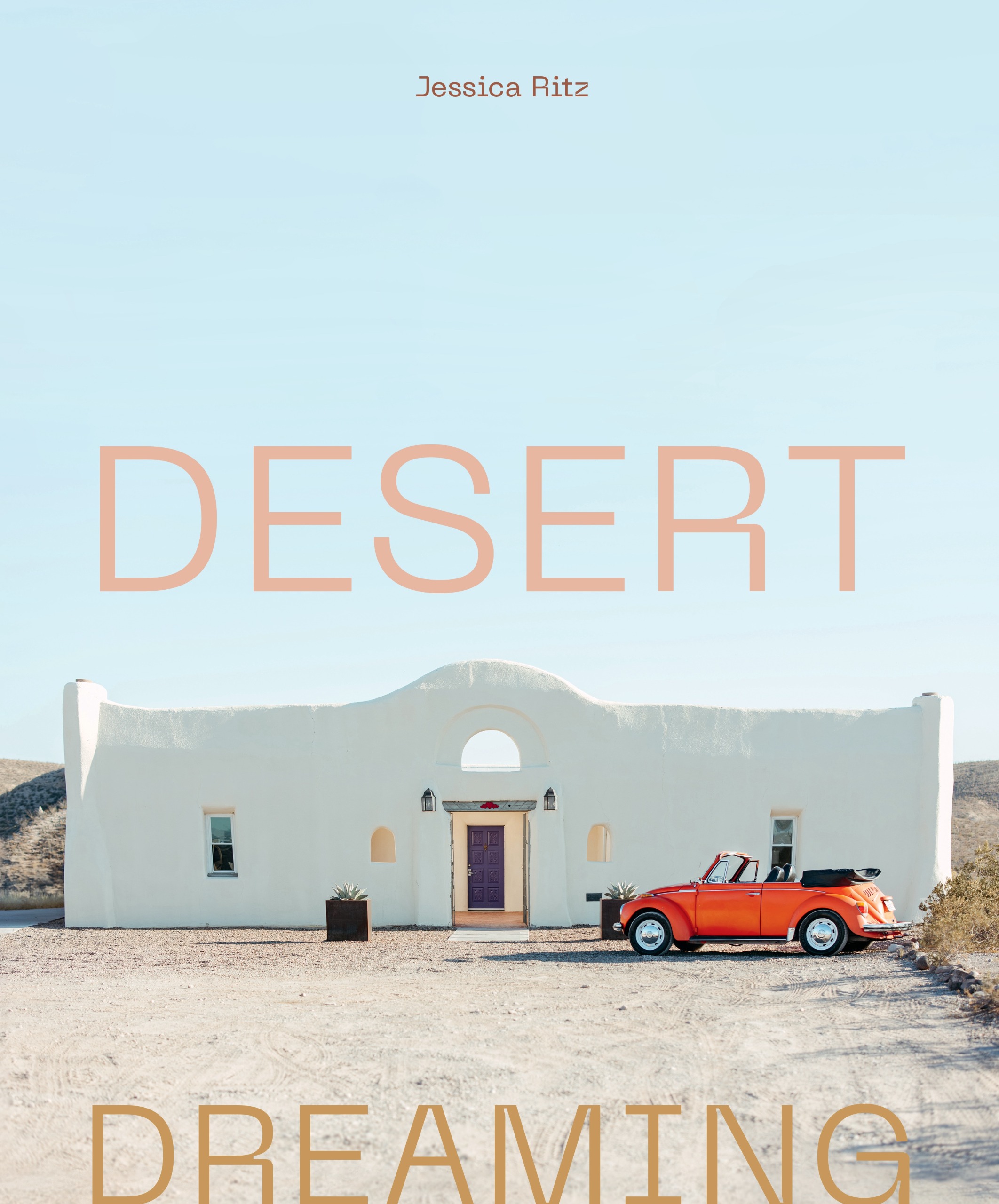 Desert Dreaming book cover showing white building against desert soil and clear blue skies