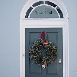 house entrance with blue door and wreath