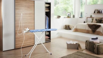 The best ironing boards: Leifheit ironing board in bedroom