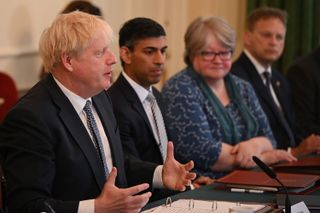 Boris Johnson sat next to Chancellor Rishi Sunak in a Cabinet meeting