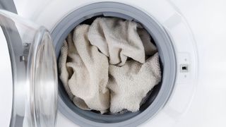 Packed washing machine with white towels