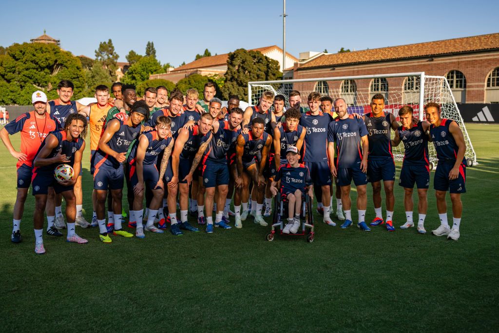 LOS ANGELES, CALIFORNIA - JULY 26: (EXCLUSIVE COVERAGE) The Manchester United pose with a fan in a wheelchair after a first team training session at UCLA on July 26, 2024 in Los Angeles, California. (Photo by Ash Donelon/Manchester United via Getty Images)