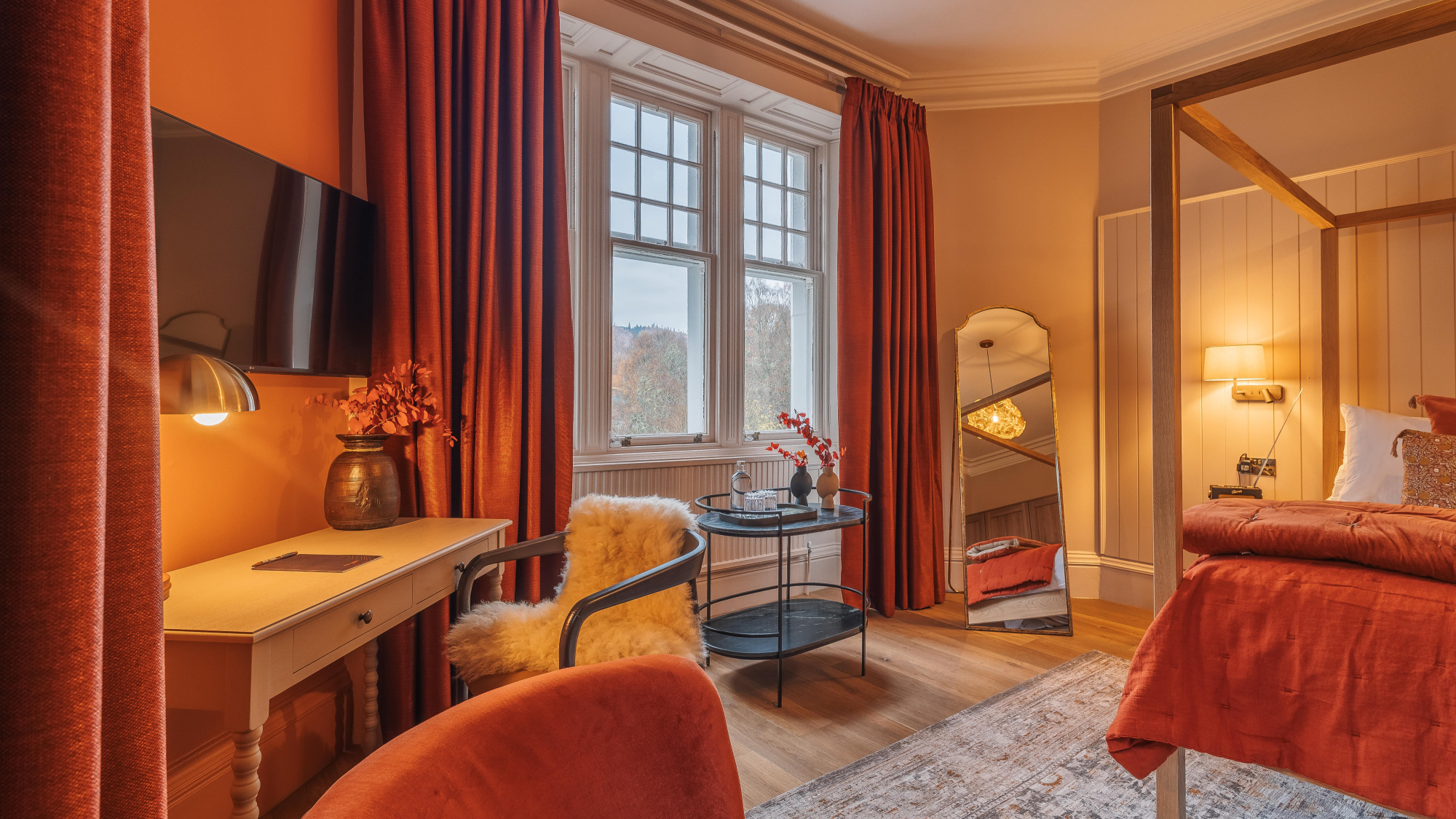 Snowdrop room, Pine Trees hotel, Pitlochry: a fourposter bed, orange curtains