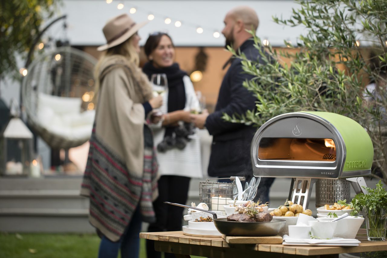 Gozney Roccbox in green set up outside at a party