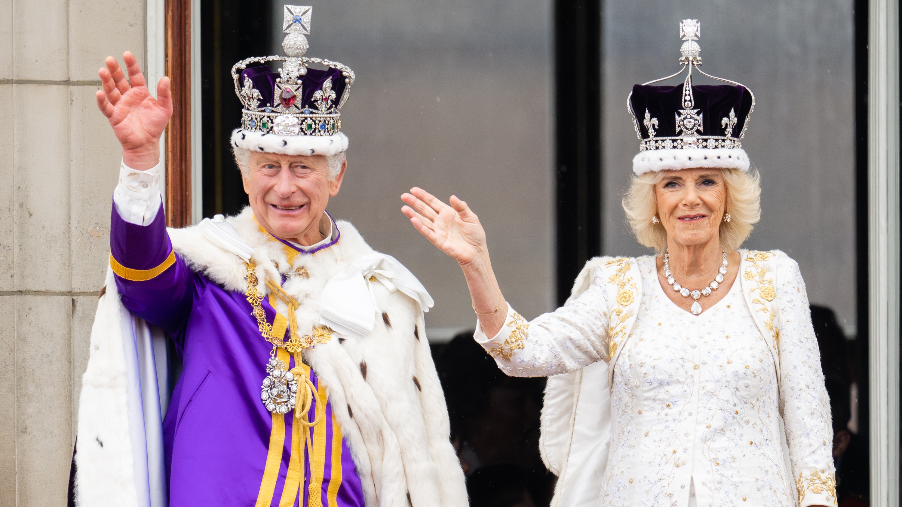 King Charles III and Queen Camilla wave on the balcony of Buckingham Palace following the coronation on May 06, 2023